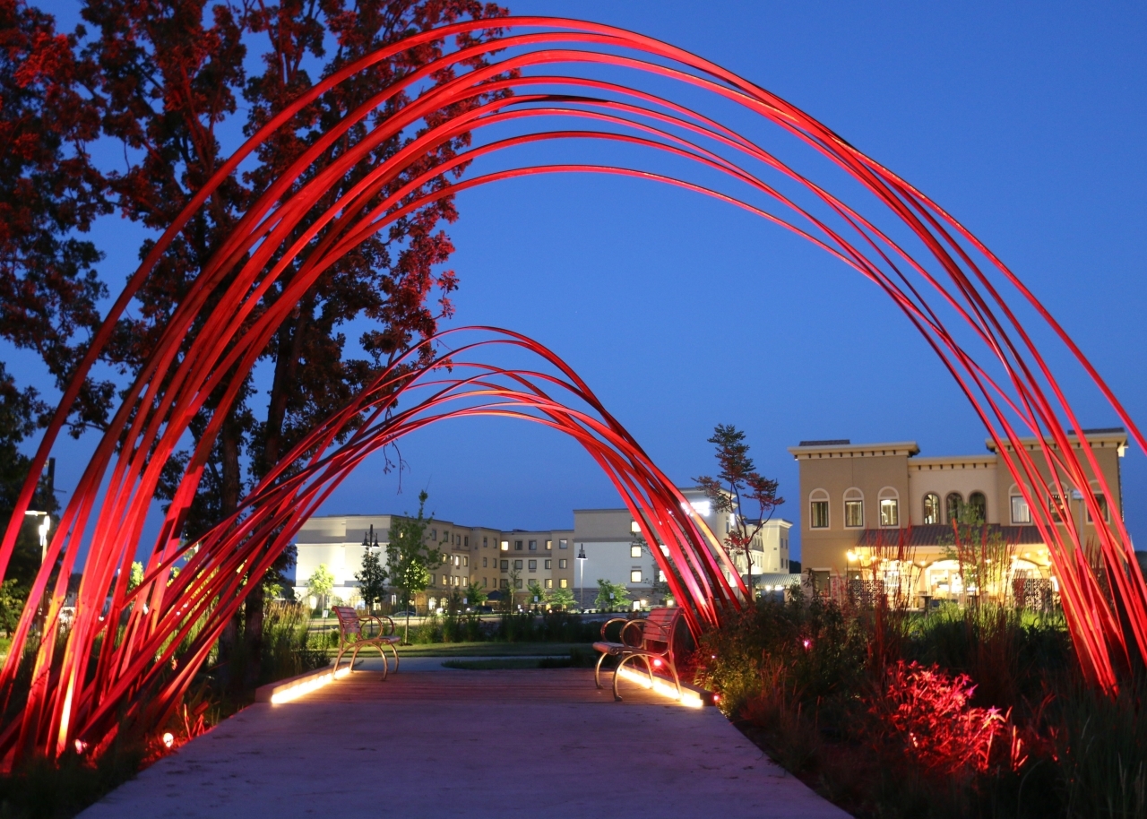 Red light arches over walkway at night